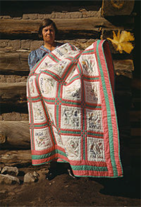 Woman holding African American Quilt from 1700s